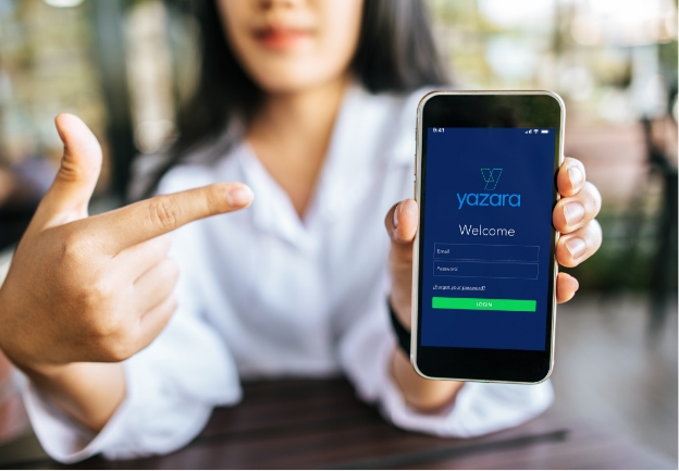 Woman pointing at her phone screen showing Yazara solution